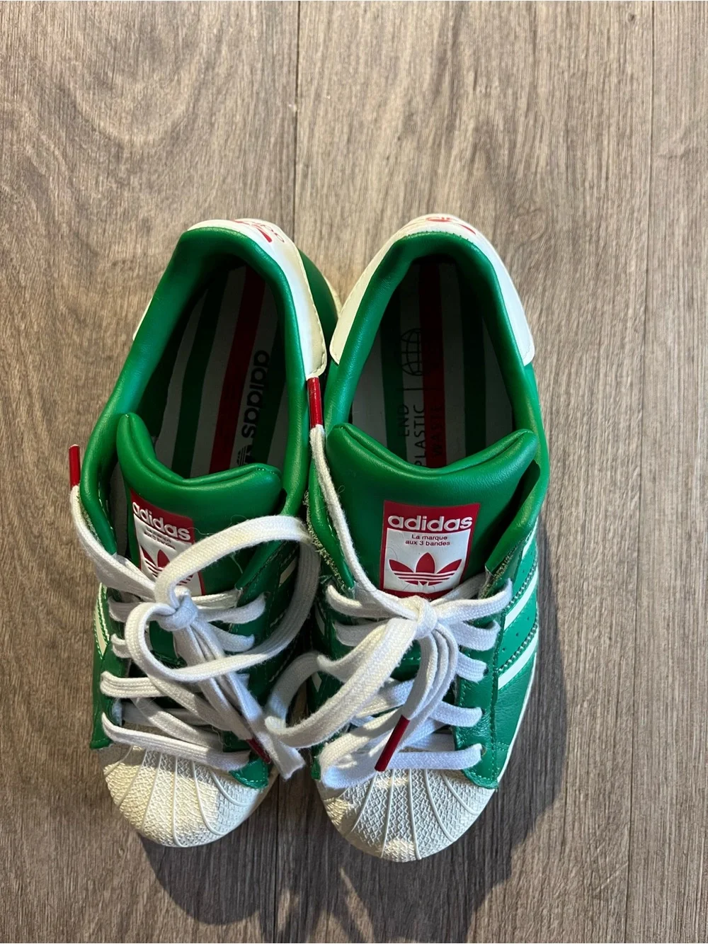 adidas women’s Green and White Superstar Sneakers with Red Logo